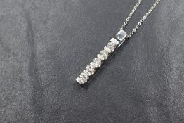 An 18ct white gold diamond set pendant, the five round brilliant cut diamonds, measuring