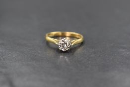 An 18ct gold diamond set solitaire ring, the round brilliant cut diamond measuring approximately 0.