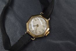 A lady's vintage 9ct gold wrist watch having Arabic numeral dial in an octagonal gold case and