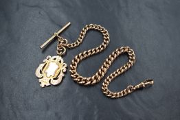 A 9ct gold graduated curb link Albert watch chain, having a dog clip, T-bar and 9ct gold shield