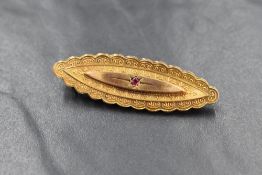 A 9ct gold 19th century mourning brooch, of lozenge form having a decorative lobed rim, set with a