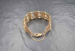 A 9ct gold six bar gate bracelet, having alternated textured and twist bars, with lobster clasp