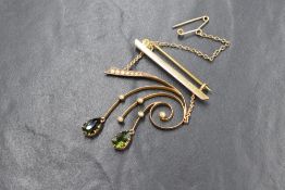 A 9ct gold green tourmaline and seed pearl set brooch, the bar brooch having a seed pearl set