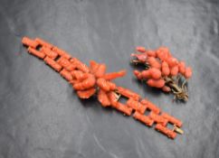 A Victorian carved coral and yellow metal articulated bracelet having a central panel of carved