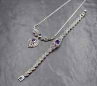 A silver amethyst and marcasite set articulated bracelet, the central oval cut amethyst in a