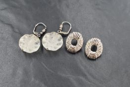 A pair of silver earrings by Lalique having crystal flower head drops from silver loops and a pair