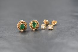 A pair of 18ct gold diamond set solitaire stud earrings, the round brilliant cut diamonds