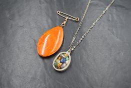 A Danish pewter pendant with chain by Jergen Jensen having polished multi stone decoration, numbered