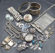 An assortment of silver and white metal jewellery, including silver hinged bangles, a painted