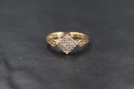 A 9ct gold diamond square cluster ring having sixteen small diamond chips in a pave set square mount