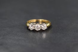 An 18ct gold diamond trilogy ring having three brilliant cut diamonds, approx 1ct total in a claw