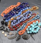 A selection of vintage costume jewellery including strings of beads, branch coral, murano glass,