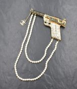 A vintage Chanel runway pistol brooch having the CC logo, onyx and rhinestone embellishment and faux
