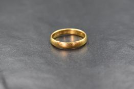 A 22ct gold band, of plain rounded form, marked 22 with hallmarks, ring size N-O, 4g
