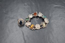 A Scottish silver bracelet having oval panels depicting luckenbooths, interspersed by five agate