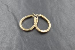 A pair of 9ct gold hoop earrings, the oval drop hoops with bar closures, marked 375, 3.4g