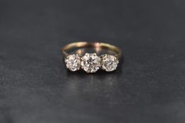 A 9ct gold cubic zirconia set three stone ring, the central cubic zirconia measuring approximately