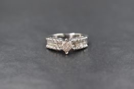 A 14ct white gold diamond set cluster ring, the central square cluster having sixteen pave set
