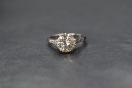 An 18ct white gold and platinum diamond set solitaire ring, the round brilliant cut diamond