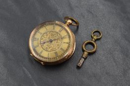 A small yellow metal key wound pocket watch stamped 14K having a Roman numeral dial to engraved gold