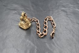 A 9ct rose gold curb link fob chain, having a dog clip, marked 375, along with a yellow metal seal