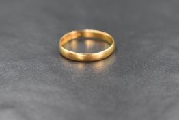 A 22ct gold band, of plain rounded form, marked 22, ring size R, 2.2g
