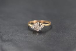 A 9ct gold diamond set cluster ring, the central round brilliant cut diamond in an eight diamond