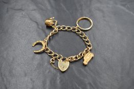 A 9ct gold curb link charm bracelet, having a 9ct gold horseshoe, 9ct gold car, 9ct gold kettle