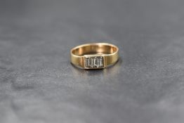 A 14ct gold aquamarine set ring, the three baguette cut aquamarines in a pressure bezel setting,