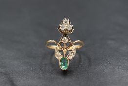 A yellow metal presumed gold emerald and diamond set Belle Epoque ring, the foliate motif setting