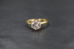 An 18ct gold diamond solitaire ring, the diamond being approx 1.28ct in a raised six claw set