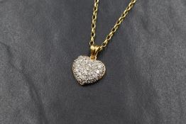 An 18ct gold diamond encrusted heart pendant having thirty five small pave set diamonds totalling