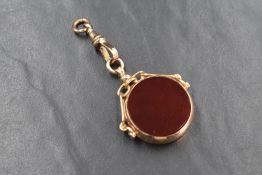 A 9ct rose gold oversized swivel fob having carnelian panel and presentation inscription en verso,