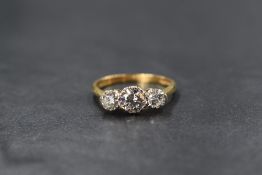 An 18ct gold diamond trilogy ring, the central brilliant cut diamond being approx 0.5ct flanked by