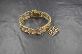A 9ct gold fancy link bracelet, the eight articulated openwork links having textured star motifs,