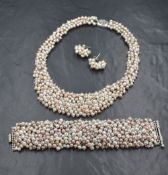 A silver fresh water pearl set suite of jewellery, comprising a necklace, bracelet and stud