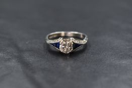 An Edwardian style gold and platinum diamond & sapphire ring having a central 0.5ct brilliant cut