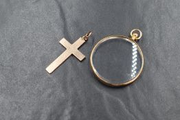 A 9ct rose gold cross pendant, of plain form, along with a 9ct gold mounted glass locket, both