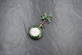 A ladies small Swiss silver and green enamel top wound pocket watch with brooch clip, the watch