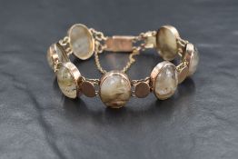 A 9ct rose gold agate set bracelet, the seven oval agate cabochons intersperesed with seven gold