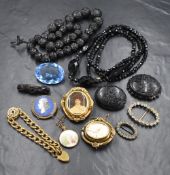 A wooden cigar box containing a selection of vintage jewellery including Mourning jewellery, two