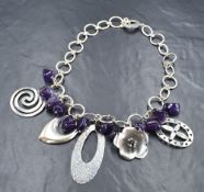 A HiHo silver necklace having five oversized charms interspersed by amethyst style charm drops allon