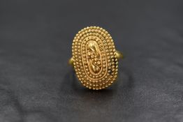 A 22ct gold ring, the oval form ring having two central teardrop motifs with four surrounding rows