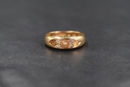 An 18ct gold pearl and diamond ring, the three pearls interspersed by two pairs of old cut diamonds,