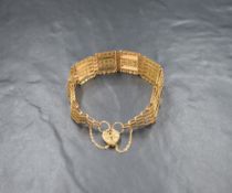 A 9ct gold six bar gate bracelet, the alternating textured and plain bars with a heart padlock and