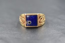A 9ct gold lapis lazuli and sapphire set signet ring, the square lapis lazuli panel having an