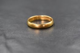 A 22ct gold band, of plain rounded form, marked 22ct with hallmarks, ring size T-U, 6.1g