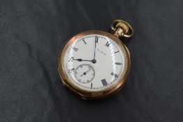A gold plated open face top wound Elgin pocket watch, the white dial having Roman numerals and