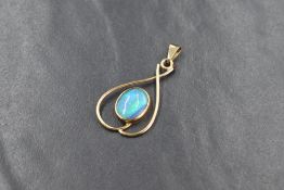 A 9ct gold opal set pendant, the oval opal cabochon in a bezel setting, within an openwork
