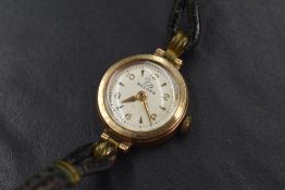 A ladies vintage 9ct gold wrist watch by Record having baton & Arabic numeral dial in a small
